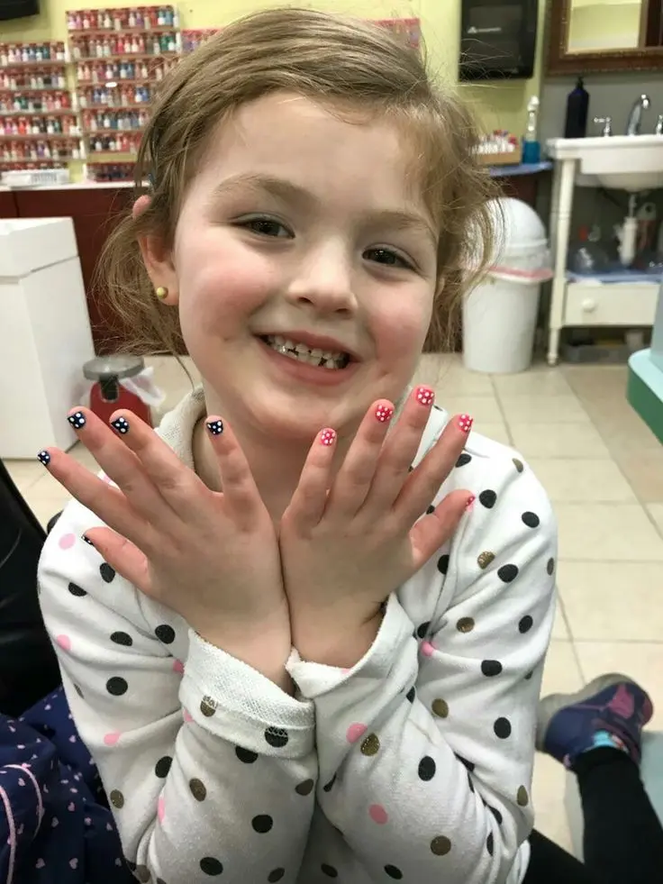 Kind nail specialist with child